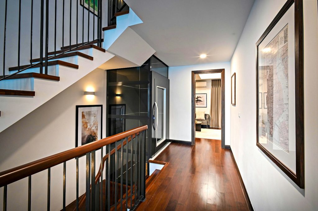 brown wooden staircase with white wooden door